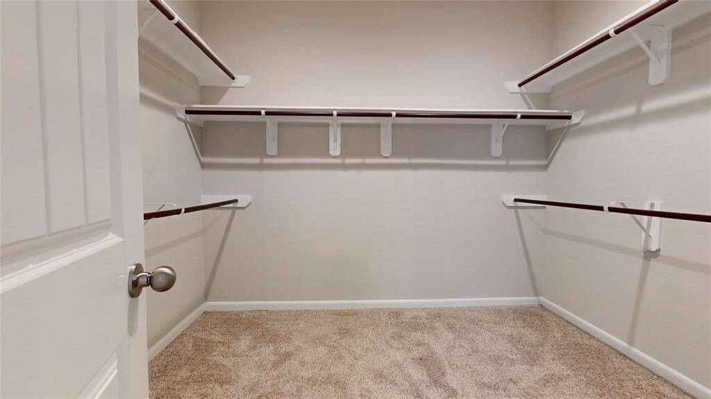 Walk-in closet in the primary bathroom.