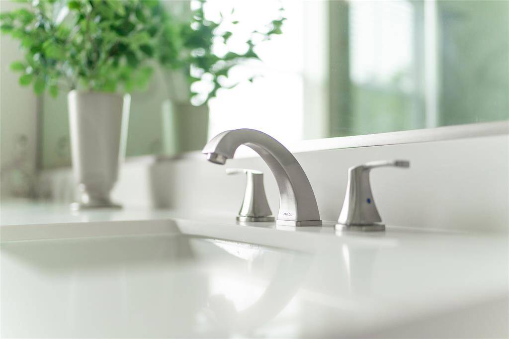 Elegant primary bath in a model home, featuring sleek fixtures and modern design.