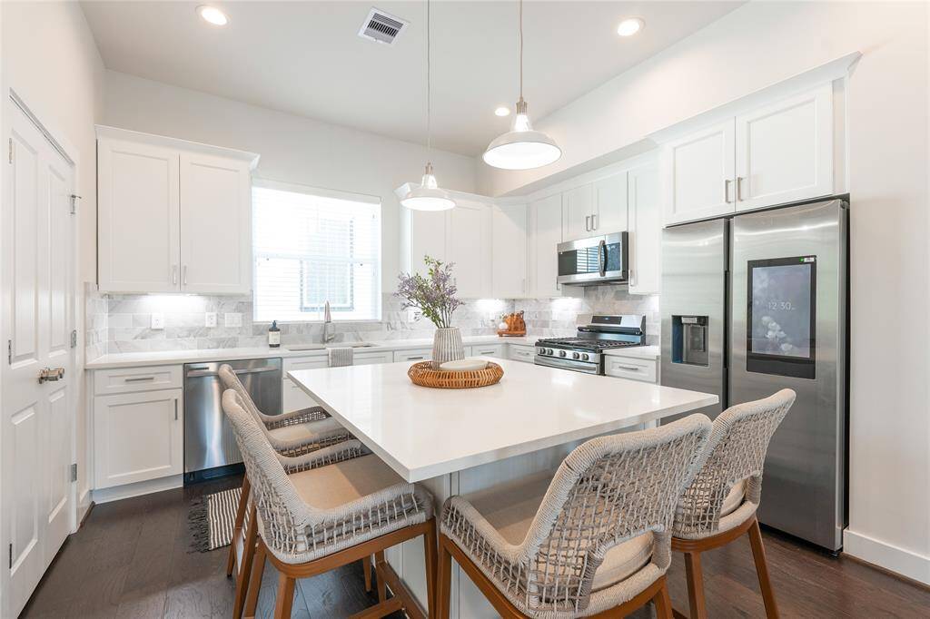 Sleek, modern kitchen with stainless steel appliances, elegant cabinetry, and a spacious island perfect for entertaining.