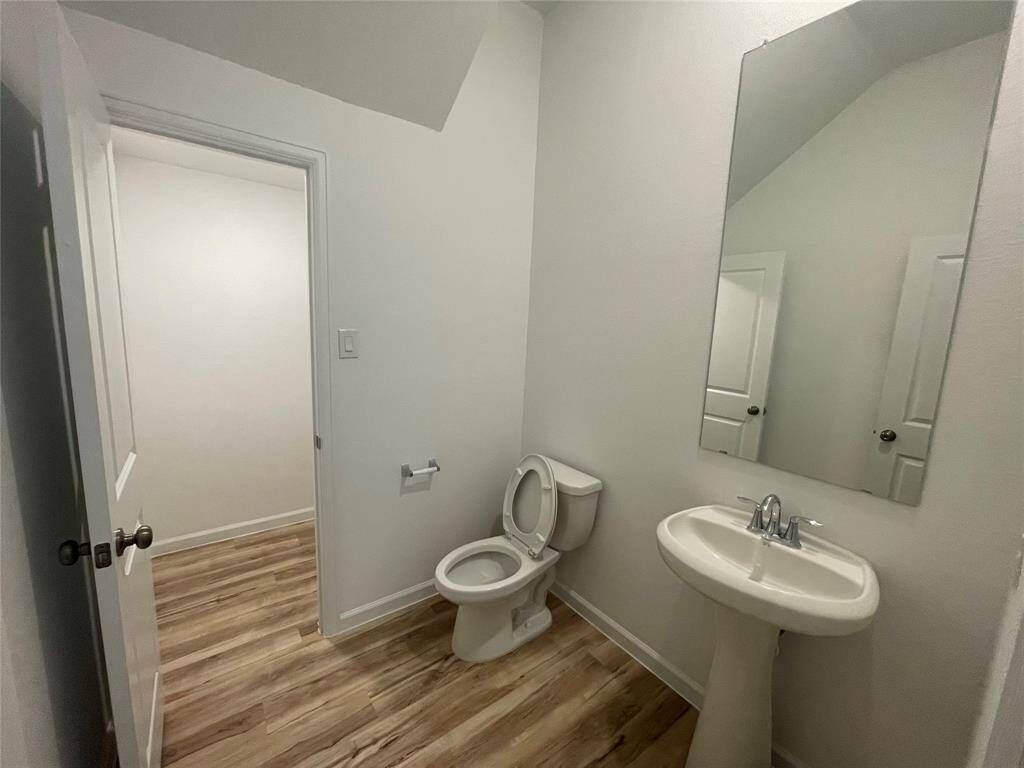 Half bath downstairs. Notice the door to the hidden storage closet.