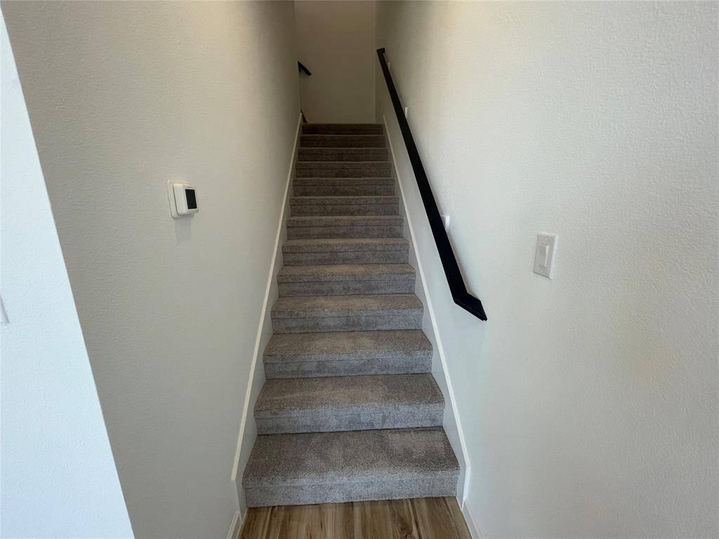 Wrap around stairs are tucked away behind the kitchen.