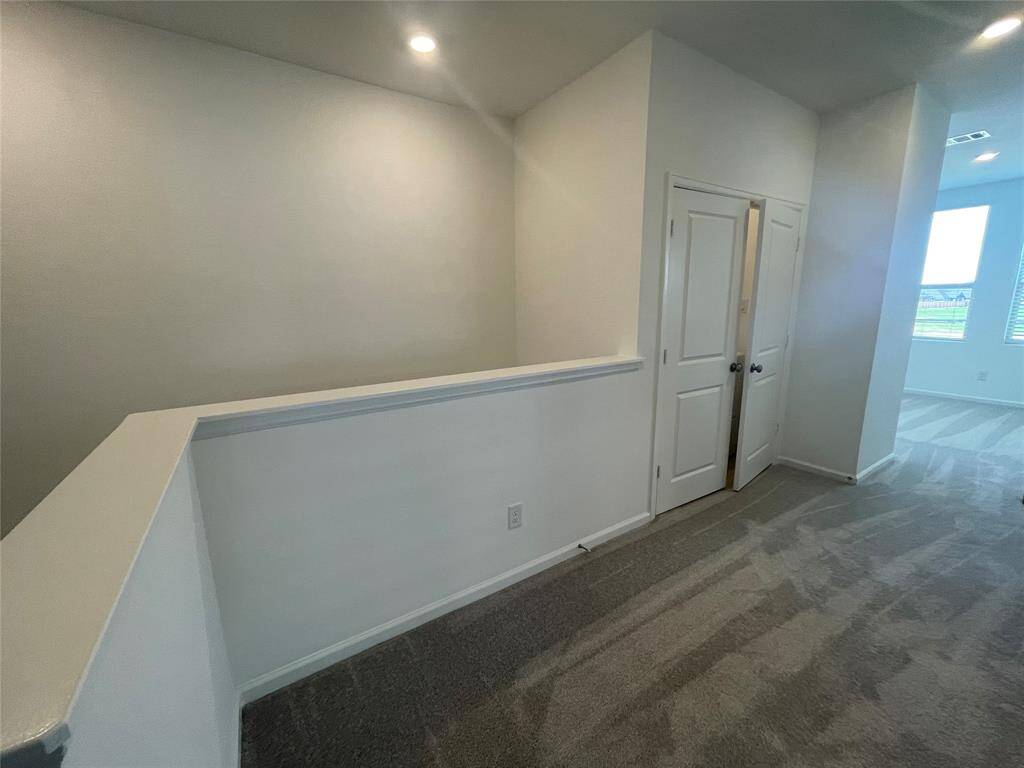 Upstairs hallway looking toward the gameroom. This nook is the perfect place for a desk. The laundry closet is behind the double doors on the left.