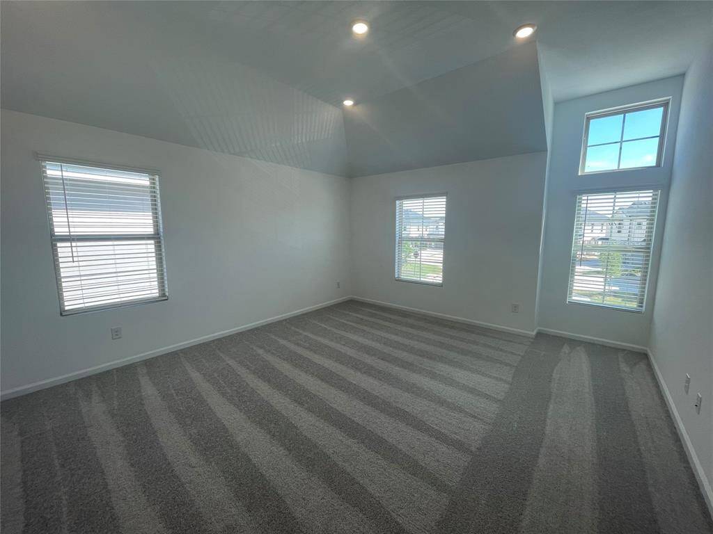 Huge primary bedroom with so much natural light.