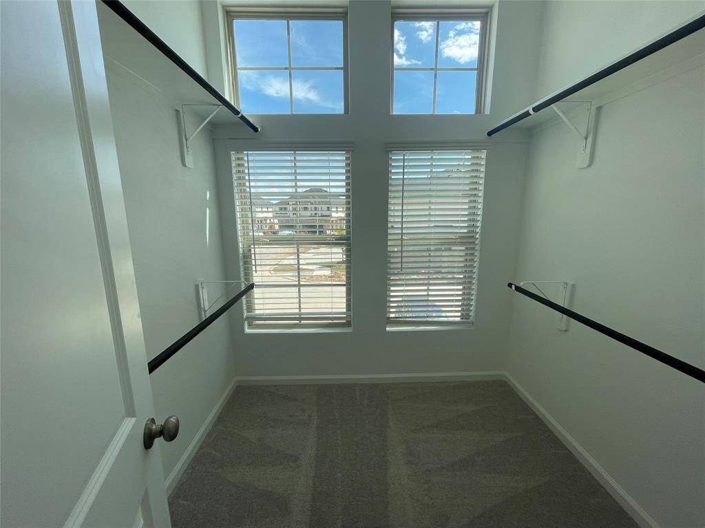 Check out the primary closet! Love these windows.