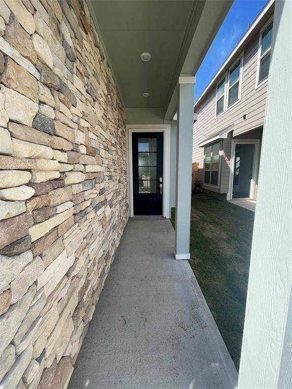 Guests and packages stay dry under the covered porch.