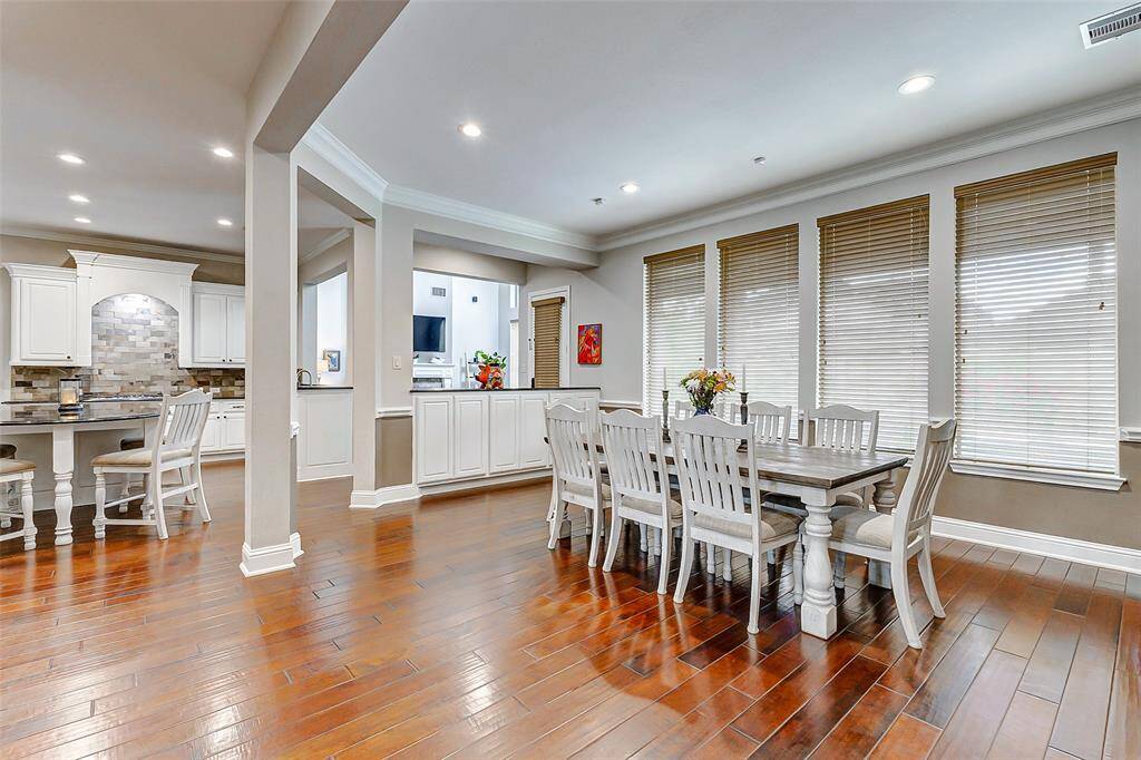 The dining area is conveniently located adjacent to the kitchen, making mealtime and entertaining effortless. Large windows fill the space with natural light, while the open layout gives it an airy, comfortable feel—perfect for both everyday dining and special gatherings.