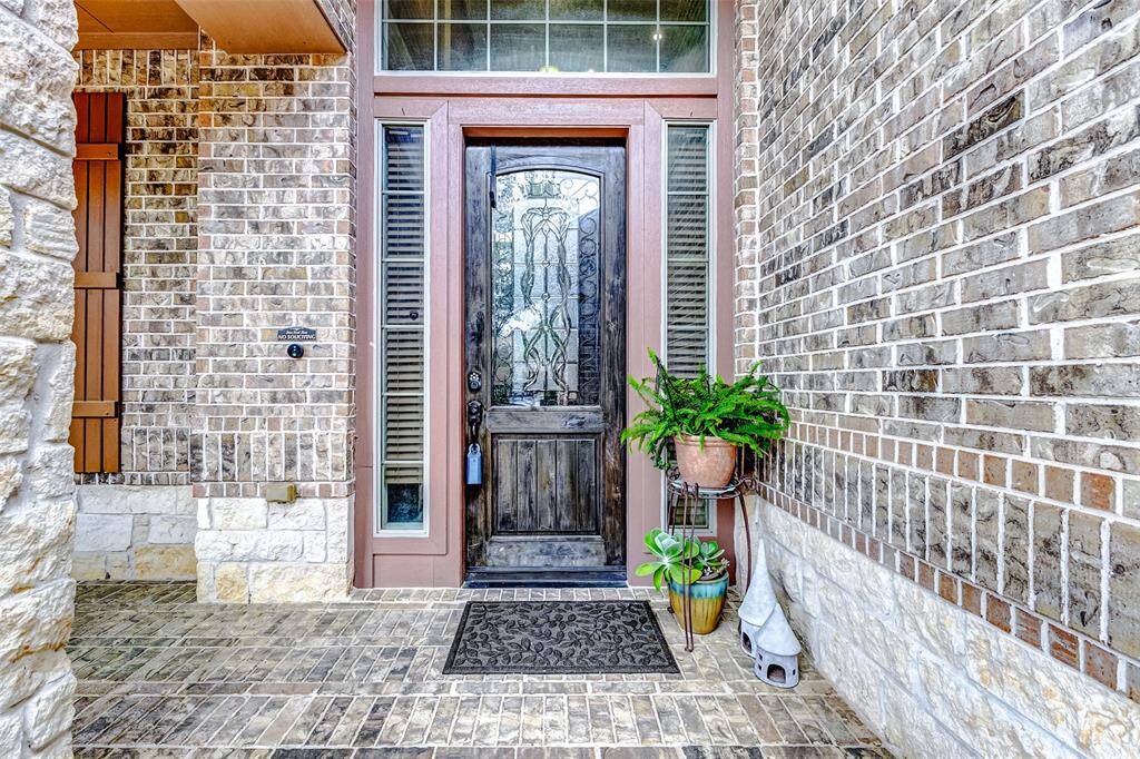 The porch, surrounded by brick, exudes both beauty and elegance, creating a welcoming entrance that adds charm and character to the home. Its classic design offers a timeless, sophisticated touch.
