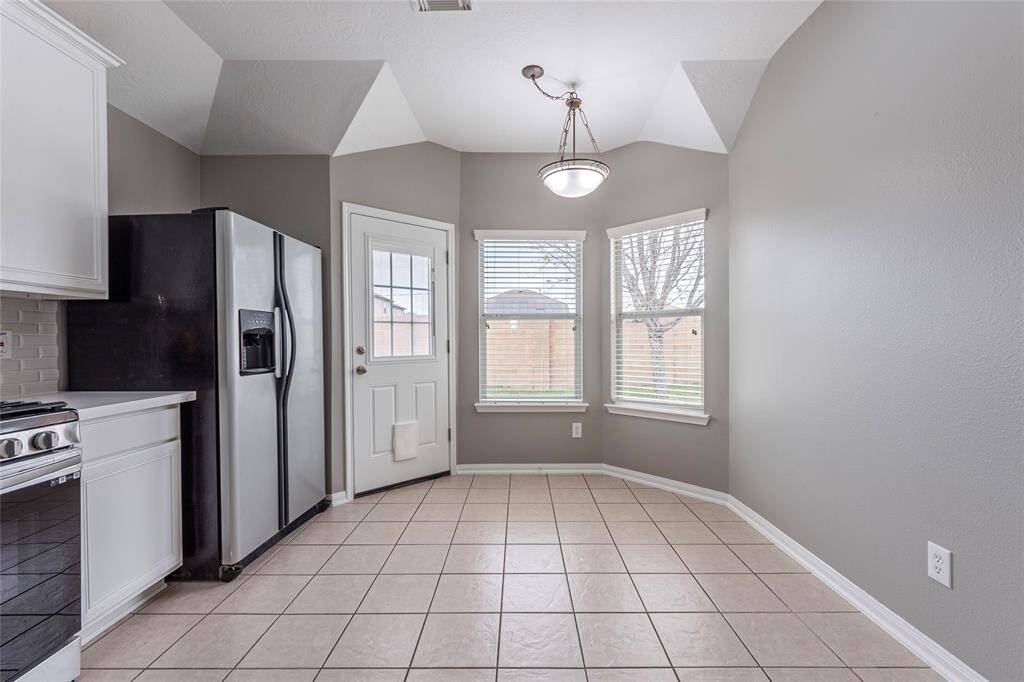 The breakfast area offers a view of the backyard.