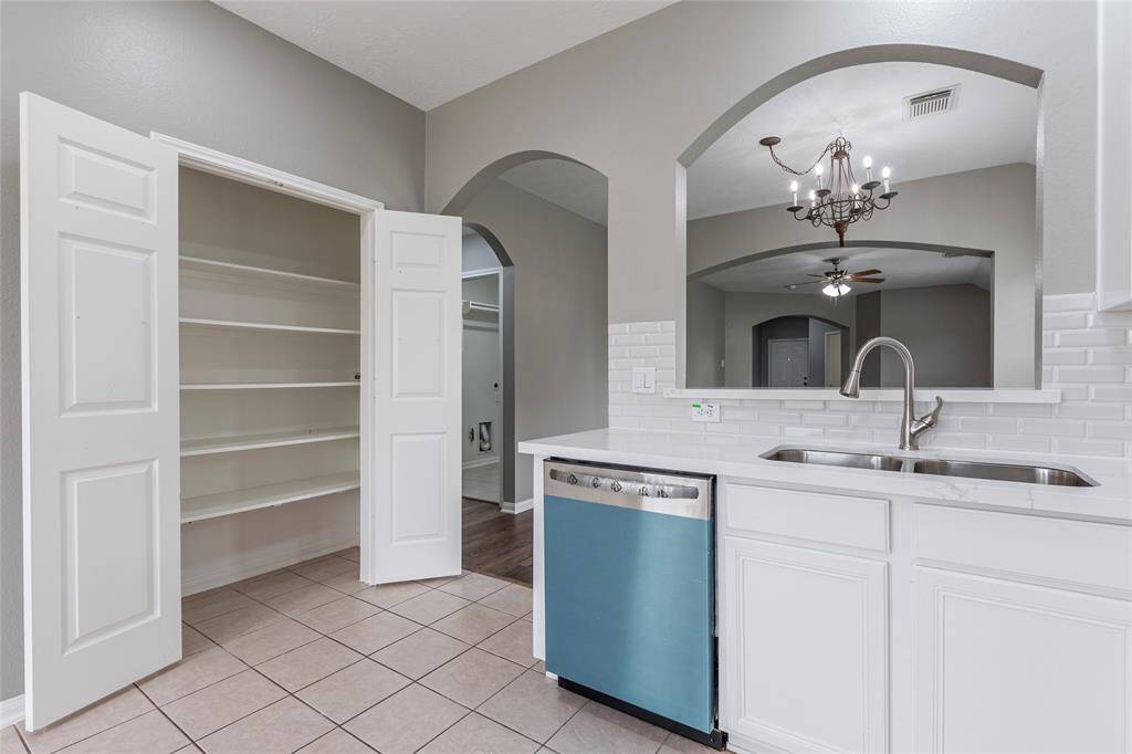 The kitchen has a large pantry with double doors.