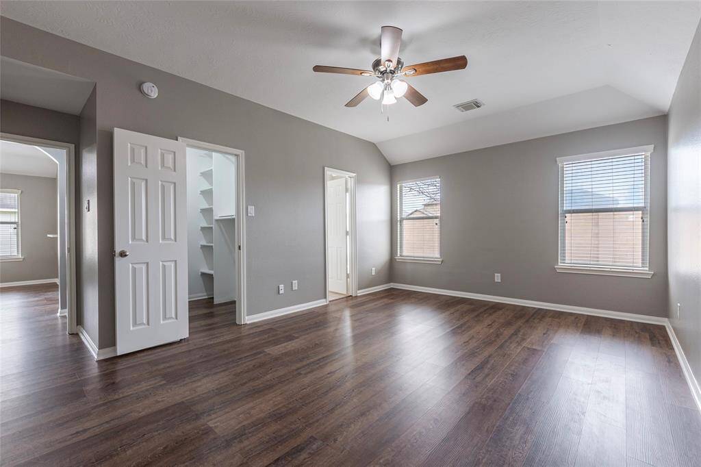 Primary bedroom with a newly installed ceiling fan.