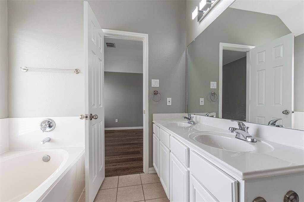 Separate soaking tub and walk-in shower in primary bathroom.