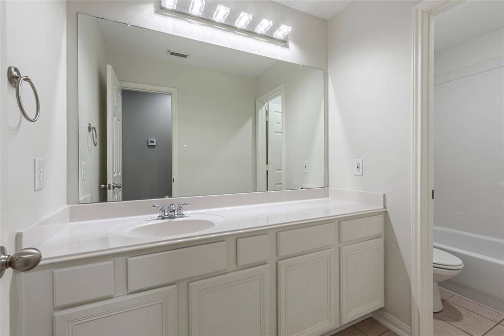 Freshly painted cabinets in bathrooms giving it a nice, updated look.