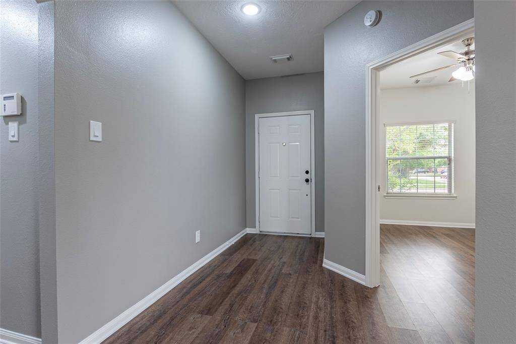 A view of the entry of the home and fourth bedroom.