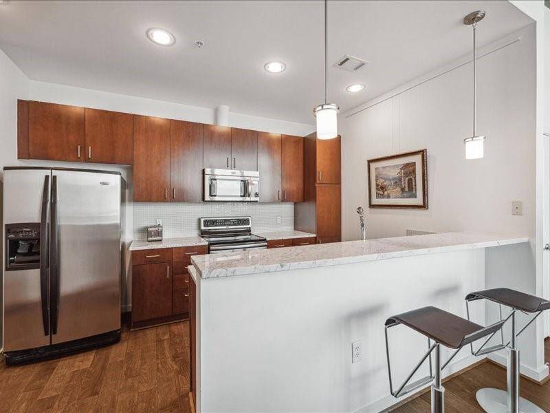 The open layout effortlessly connects the kitchen to the family room with a breakfast bar, creating an ideal space for entertaining and family gatherings.