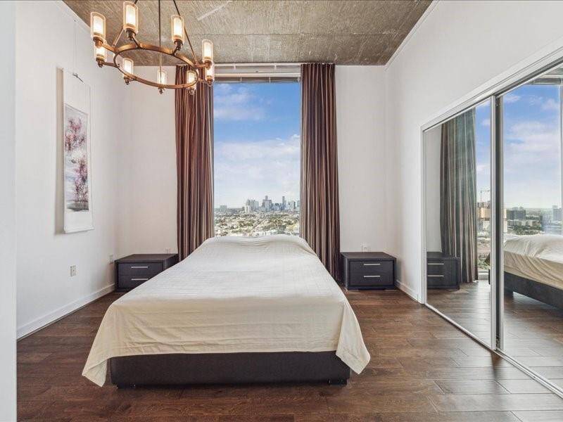 Experience the stunning ensuite secondary bedroom featuring floor-to-ceiling windows that soar to 11 feet high.