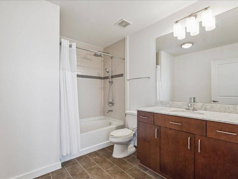 Secondary ensuite bathroom upgraded with Grohe retro-fit shower system featuring deluxe bath shower head and a convenient handheld shower head for enhanced convenience and functionality.