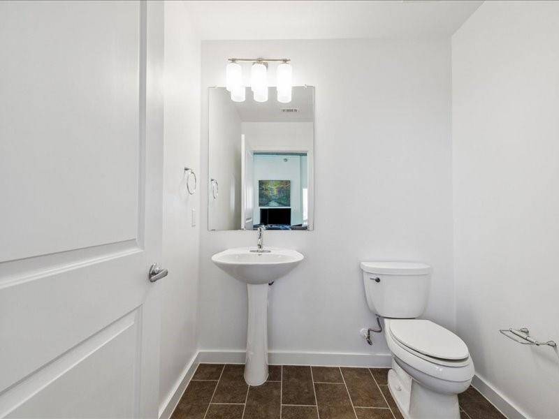 Conveniently located off the living room, this half-bathroom adds comfort and accessibility.