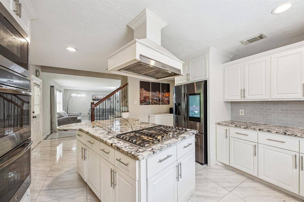 Custom built kitchen with soft closing shelves and cabinets. Gas cooktop and double ovens to prepare a feast for you loved ones.