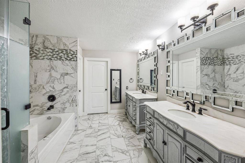 Custom primary bathroom. Separate garden tub and walk in shower. Separate vanity sinks and a large walk in closet.