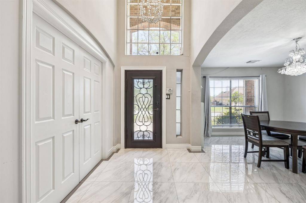 Welcome in. This light and airy foyer with custom chandelier is breath taking.