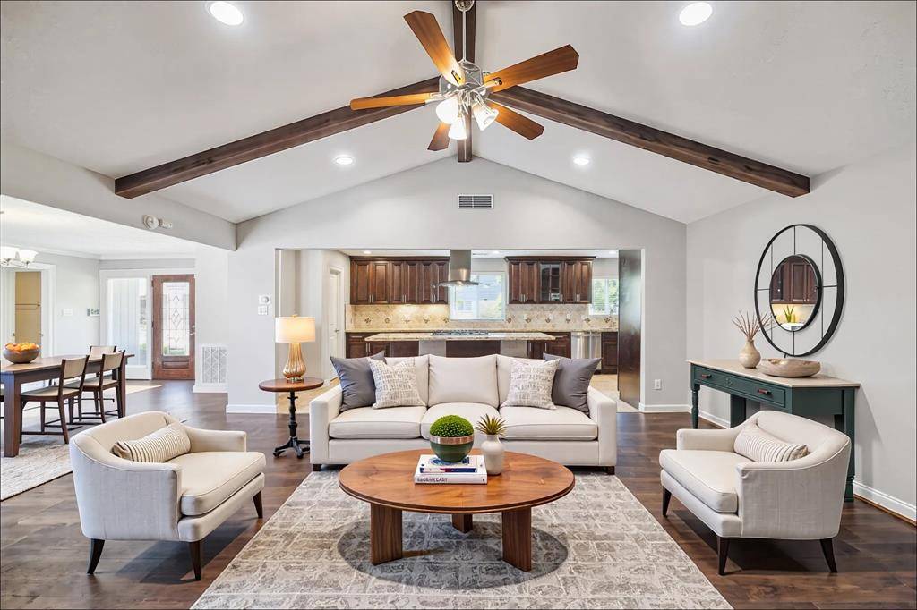Hardwood beams and vaulted ceilings complement this open living space.