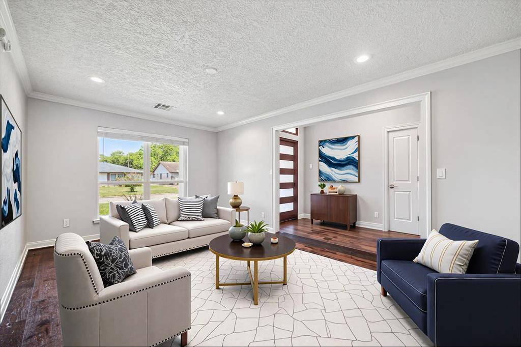 Natural light pours into this formal living space. Photo is virtually staged.
