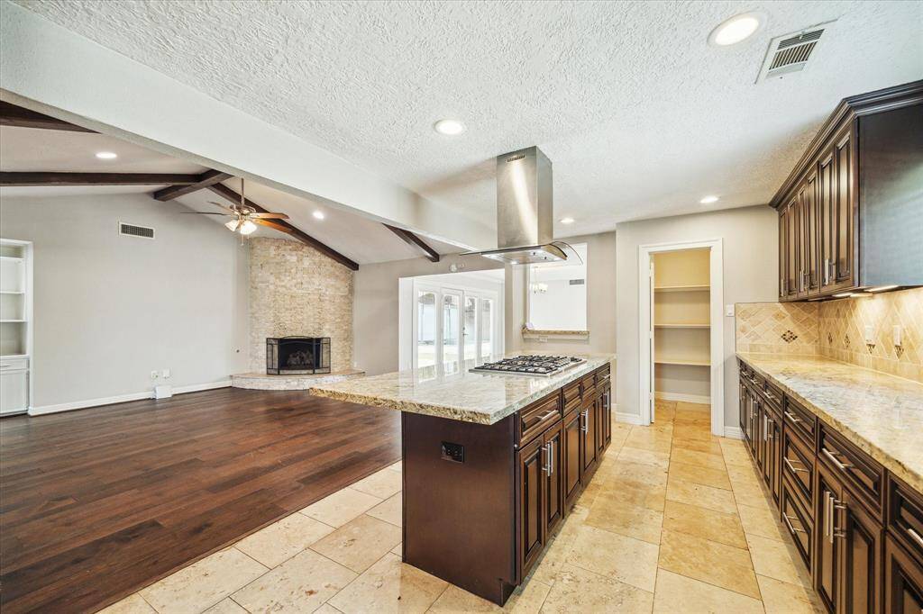 The heart of the home, the kitchen showcases granite countertops, bar seating and a walk-in pantry.