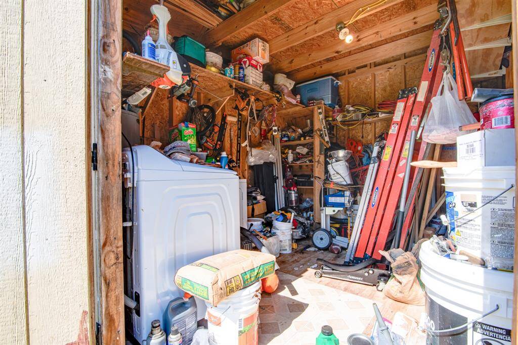 Washer, dryer, and water heater located in outside shed.