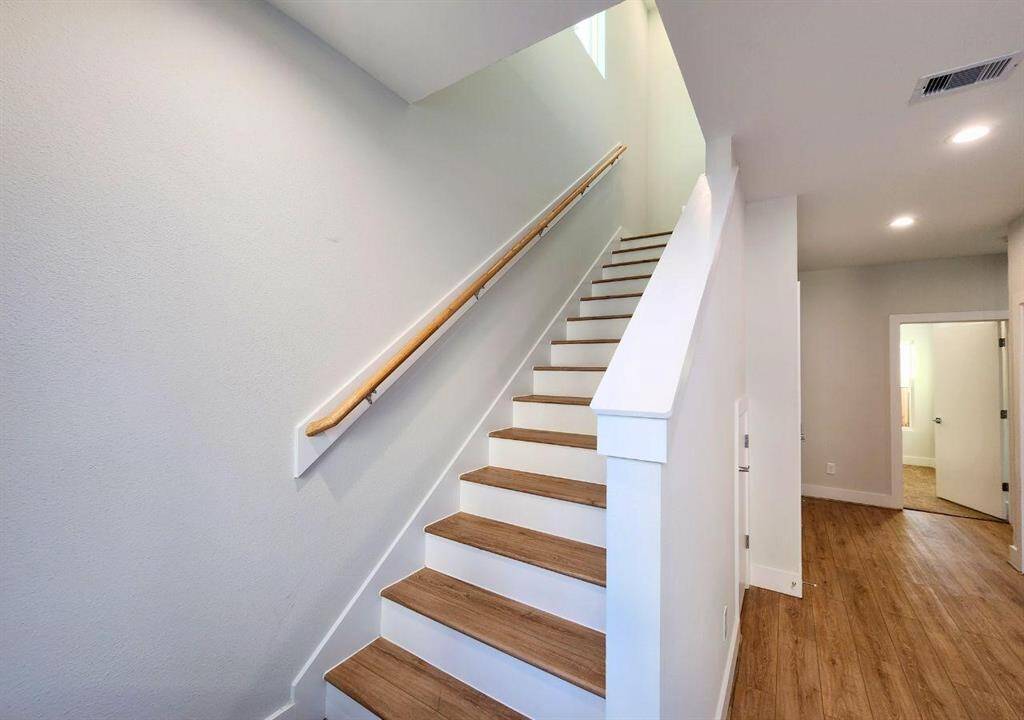 First floor stairwell reaches second floor living area and primary bedroom.