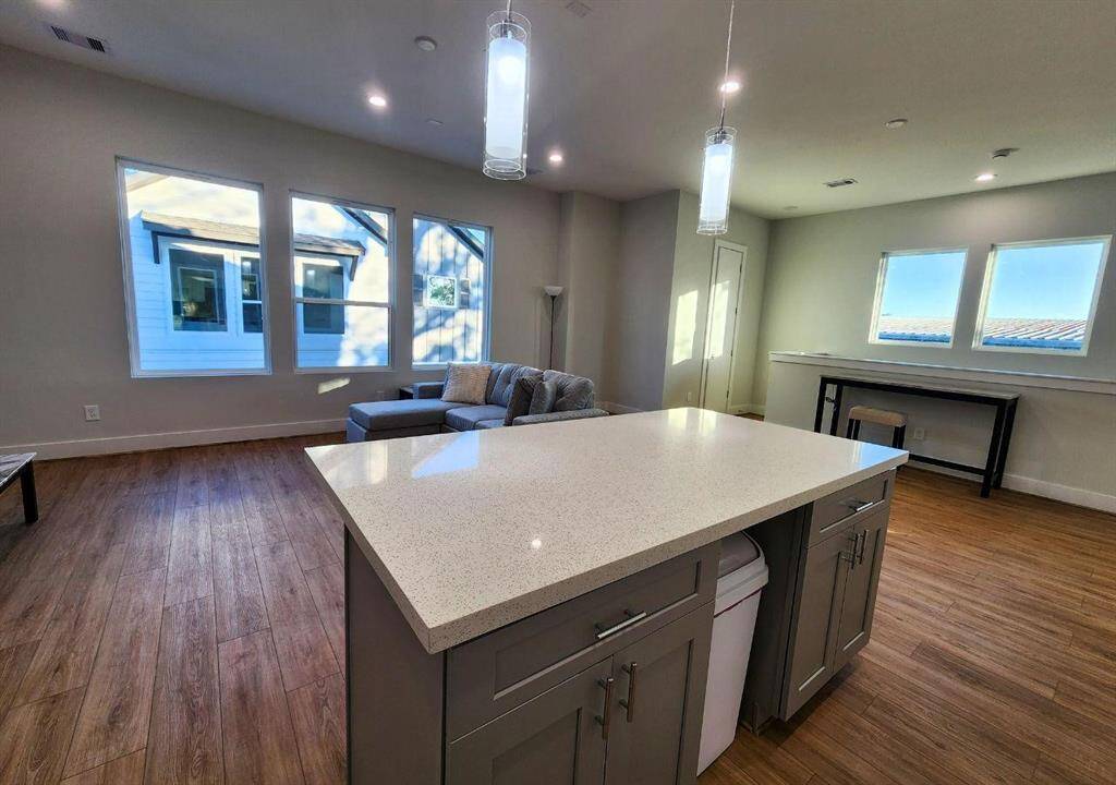 Island in kitchen looks out to the expansive windows on the second floor for lots of natural light.