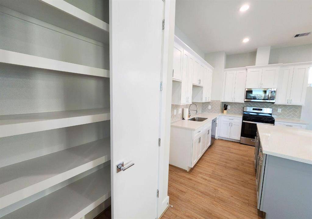 Huge floor to ceiling pantry is perfect space for your kitchen needs.