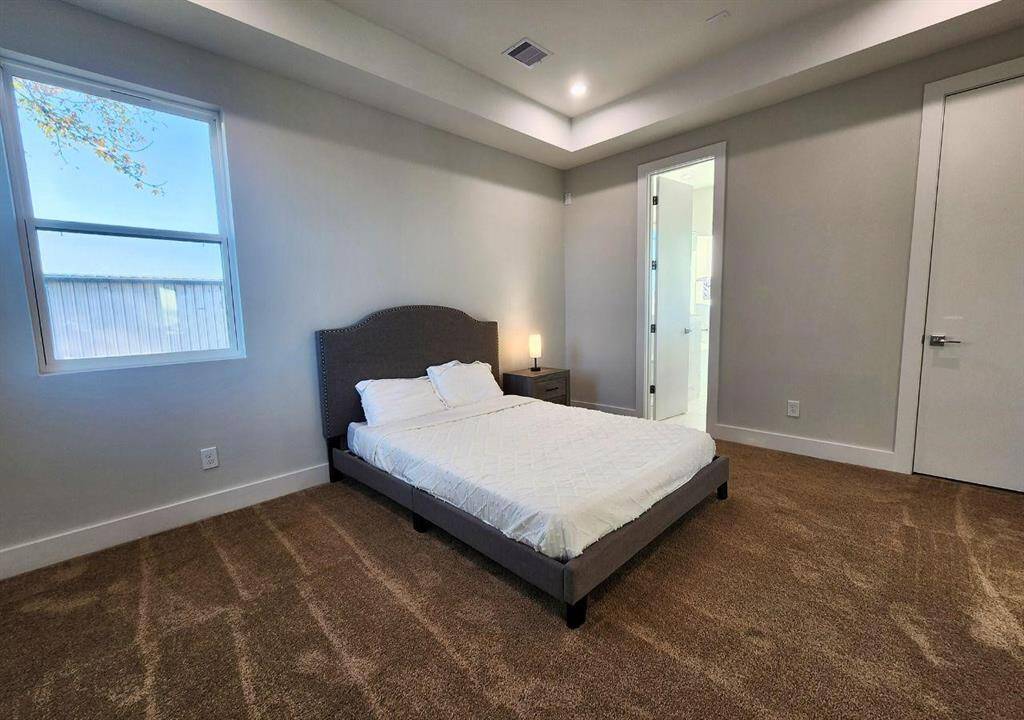 Large windows flood the room with natural light.