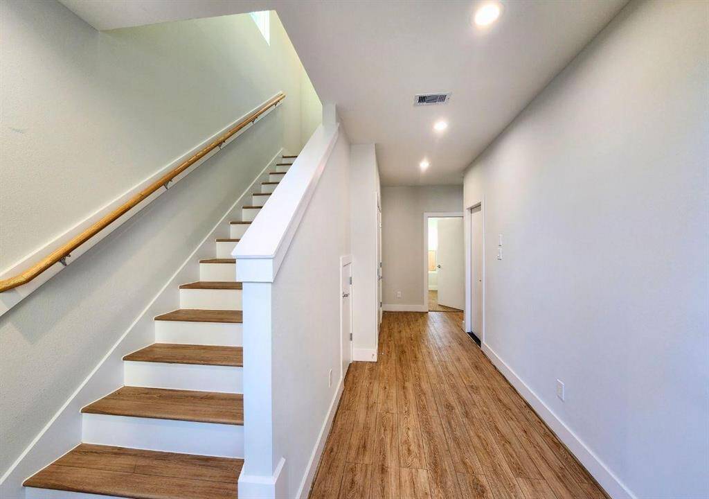 Wood styled flooring throughout the unit. Downstairs secondary bedrooms and washer and dryer hookups.