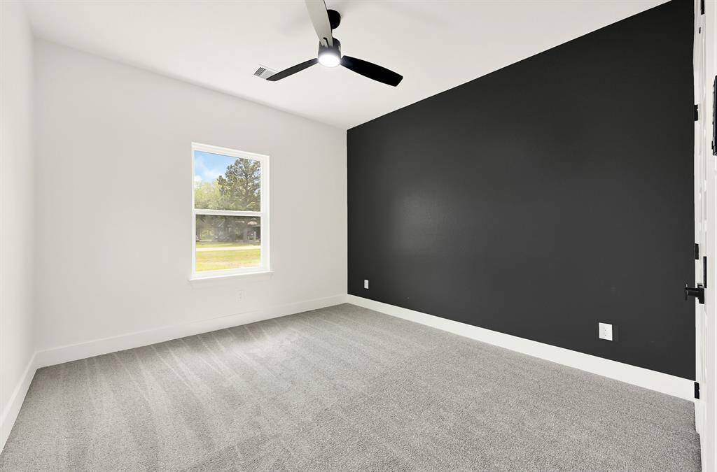 Primary walk in closet with custom storage racks