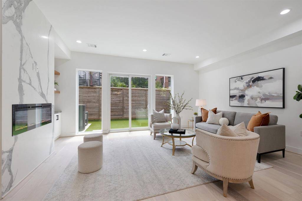 Enjoy book matched slabs behind the fireplace and expansive sliding doors to your tured yard space.