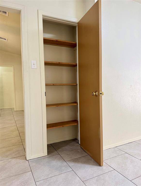 A convenient pantry with built-in shelves keeps your food items, small appliances, and kitchen essentials neatly organized and easily accessible—making meal prep and storage a breeze.