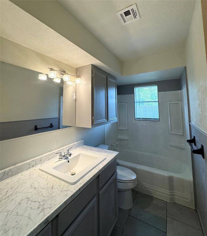 The bathroom features a versatile shower/tub combo, perfect for both quick showers and relaxing baths. A spacious vanity with a large mirror and ample cabinet under-storage provides plenty of room to keep your essentials organized and easily accessible.