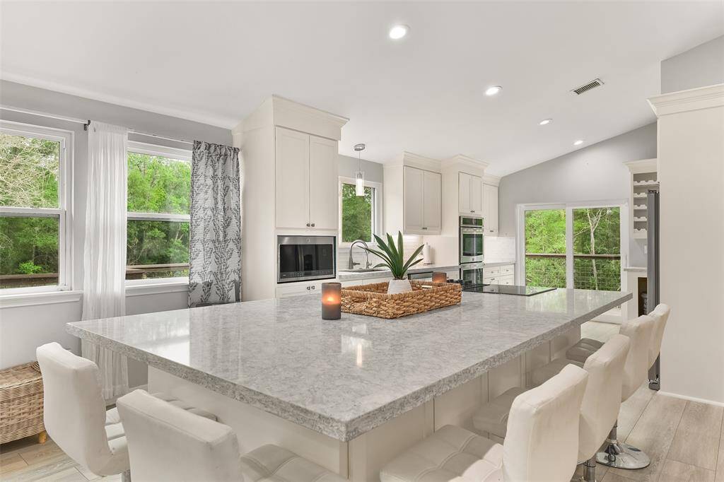 As you enter the kitchen, you'll immediately notice the large windows that flood the space with sunlight. The bright and airy ambiance creates a refreshing and uplifting environment, perfect for starting your day or preparing delicious meals.