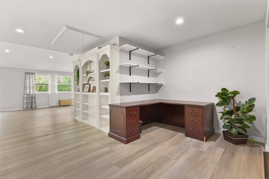 This small space serves as a versatile area that is currently being used as an office, but it also has the potential to transform into a delightful play area and toy space.