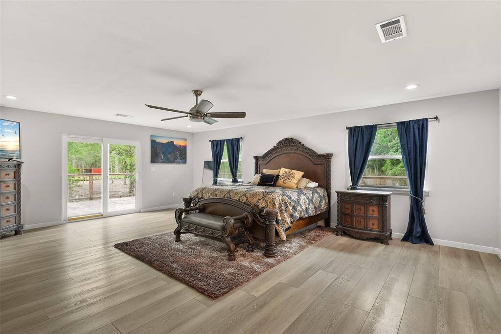 This generously sized primary bedroom offers a peaceful retreat, featuring its own private en-suite bathroom as well as access to the wrap around porch.