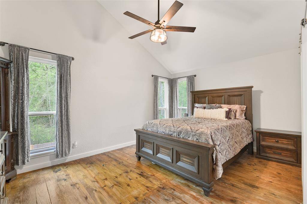 Secondary bedroom, a luxurious retreat within the home. This spacious room boasts beautiful real wood floors that add warmth and elegance to the space. The highlight of this bedroom is the walk-in closet, offering ample storage space for all your belongings. Additionally, the attached full-size bathroom provides ultimate comfort and convenience, ensuring a private oasis for guests or family members.