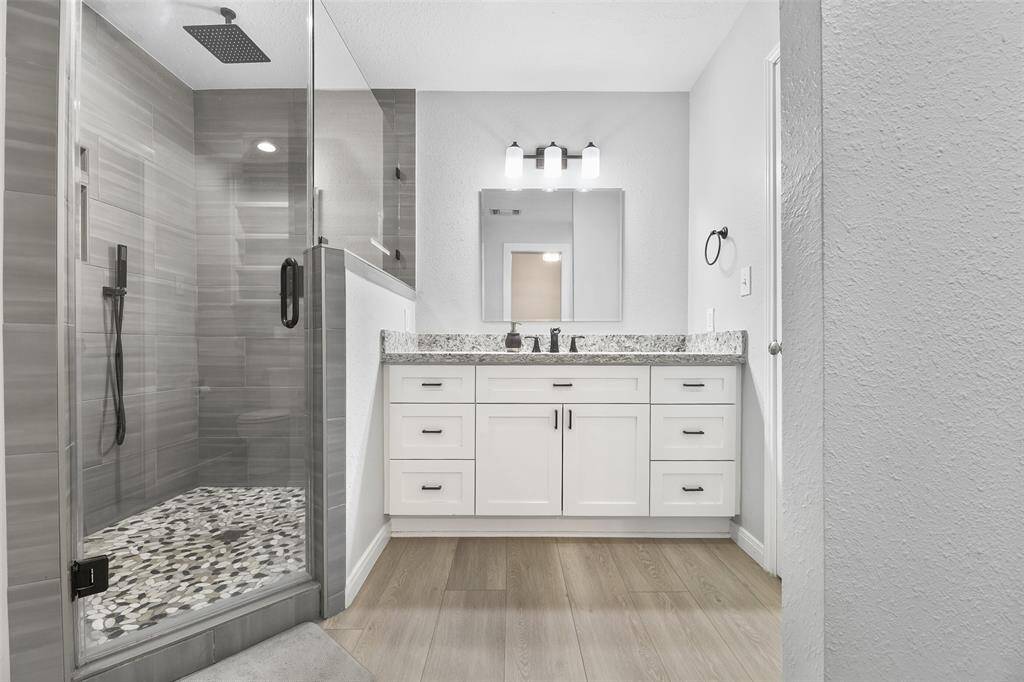 This updated en-suite offers a luxurious and contemporary design. The highlight of this space is the spacious walk-in shower, providing a spa-like experience.