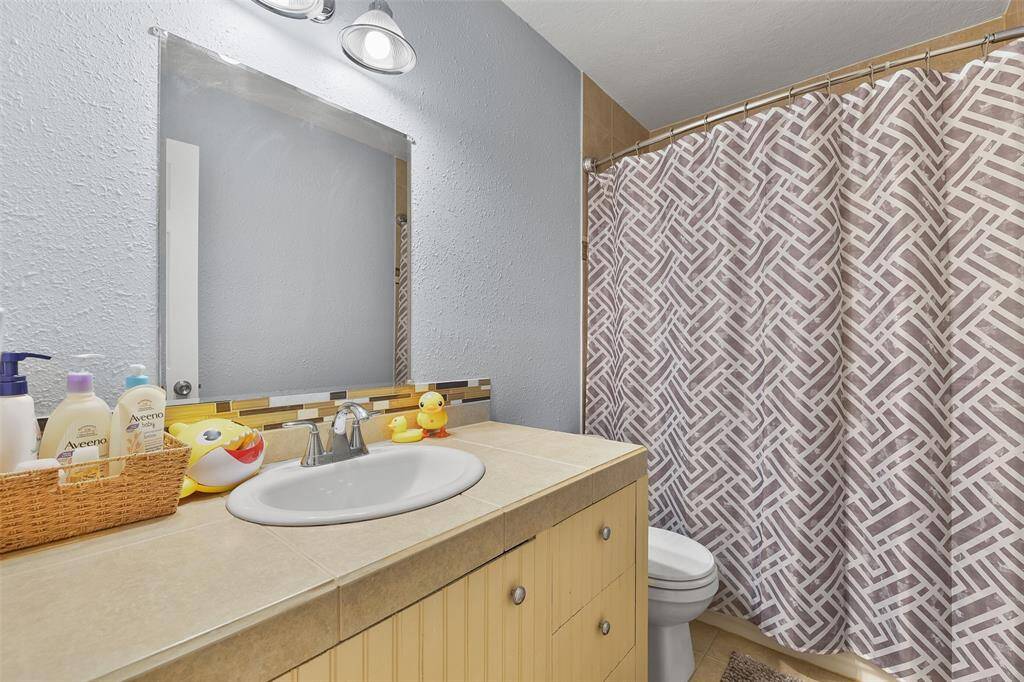 Conveniently attached to the baby's room, this full-size bathroom provides a private and functional space.