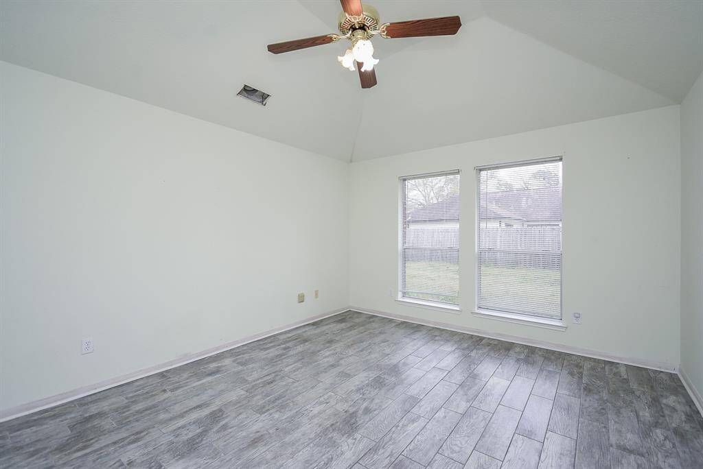 Primary bedroom- high ceiling and lots of natural light