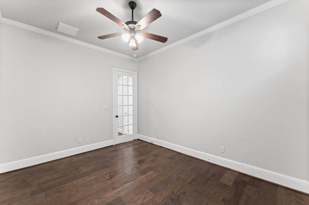 Elegant French door enhances the room's charm, offering style and natural light.