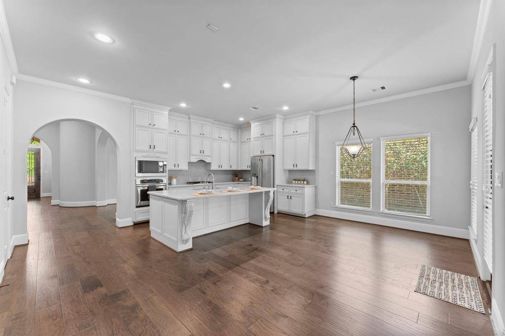 Elegant kitchen featuring floor-to-ceiling cabinets and sleek quartz countertops.