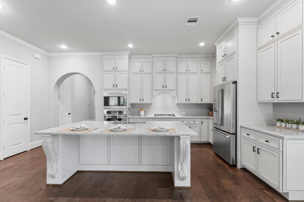 Decoratively detailed island with breakfast bar for casual dining.