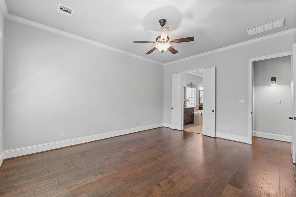 Spacious primary bedroom with luxurious en suite bath.