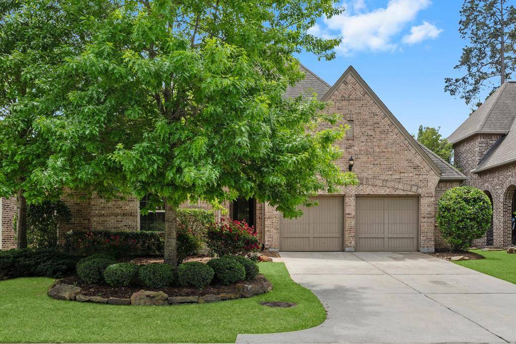 Charming brick home with lush landscaping.