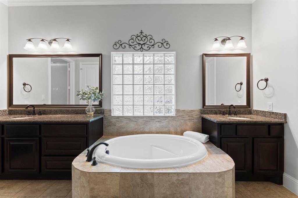 Large soaking tub and  a glass-block window for natural light.